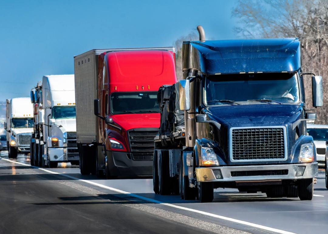 Row of trucks driving on highway