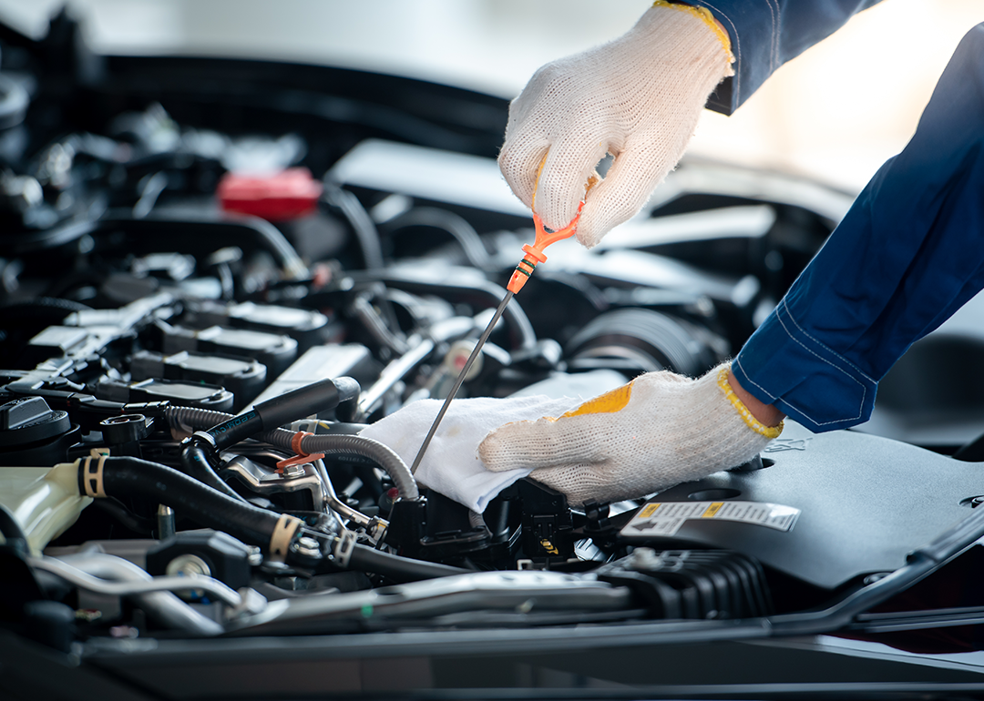 A mechanic checking a car engine.