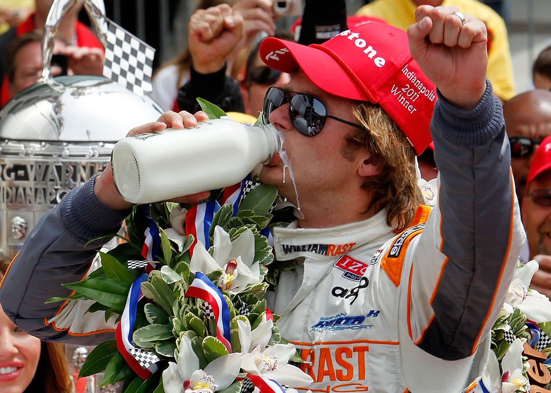 Dan Wheldon drinks milk in the victory lane.