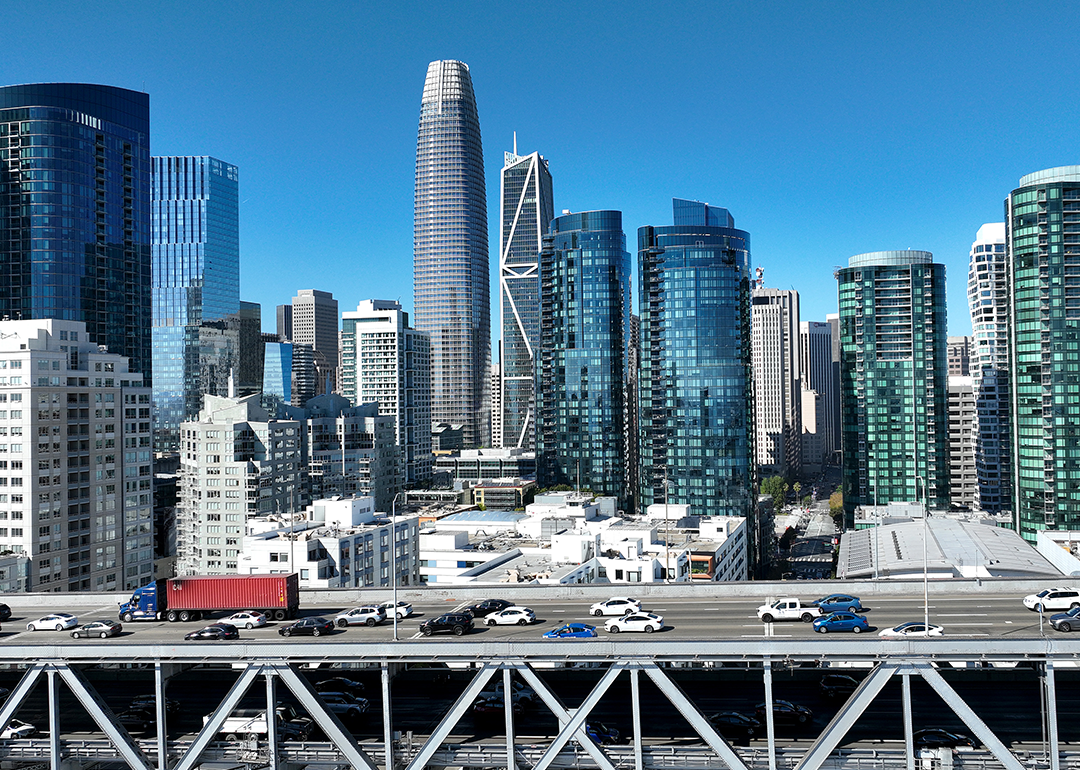 Cars drive the San Francisco skyline along Interstate 80.
