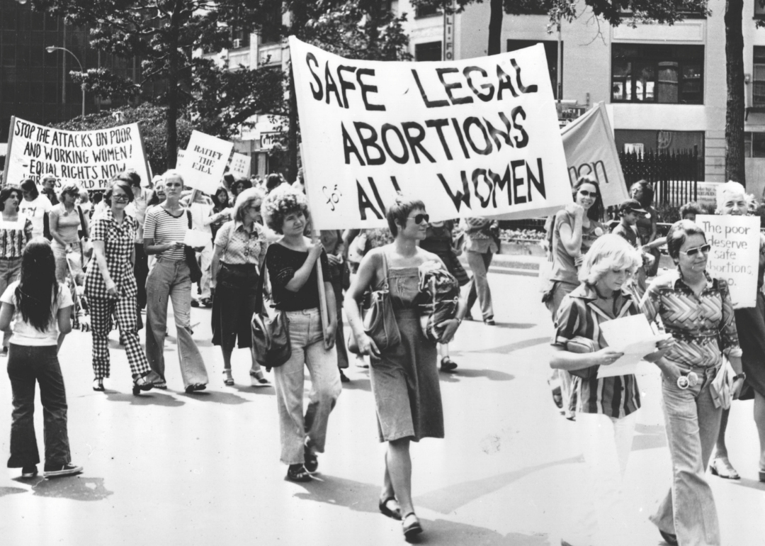 Women in a demonstration with ‘Safe Legal Abortions for all Women’ sign