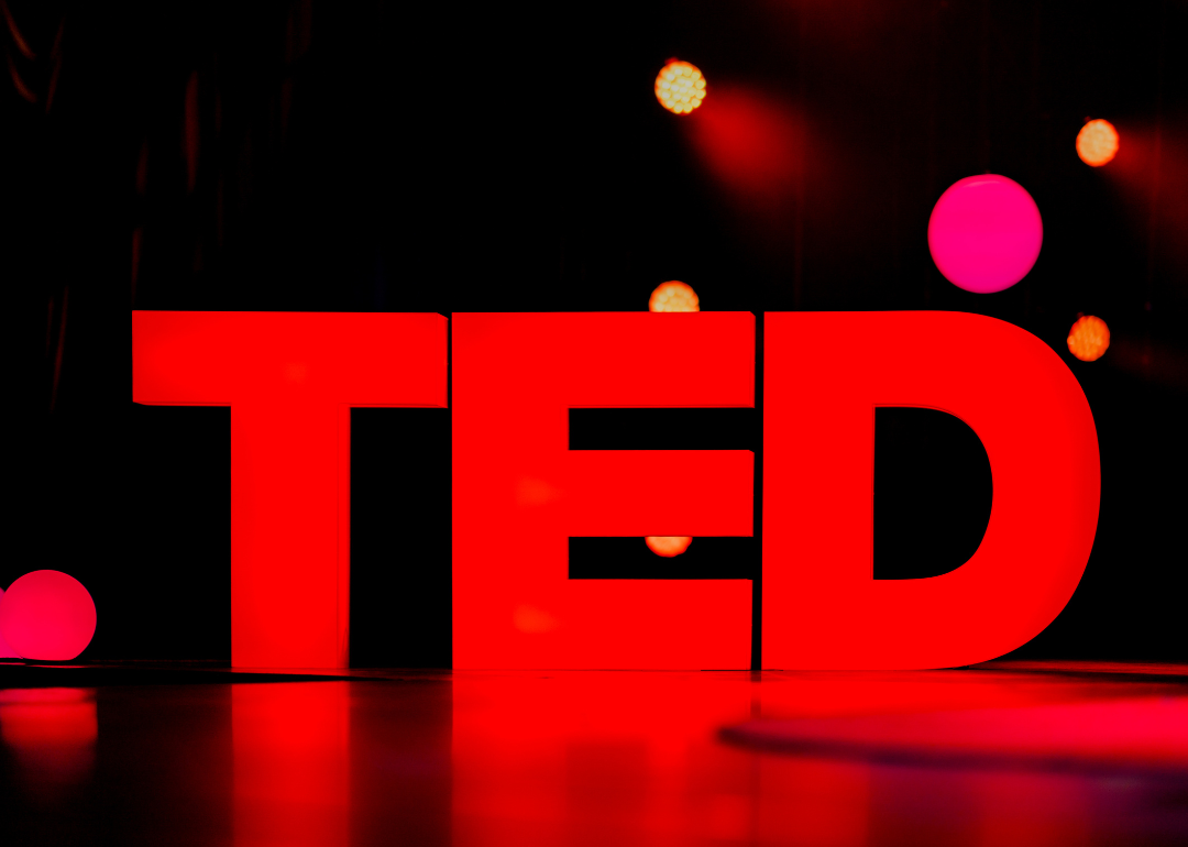 The TED logo illuminated on stage