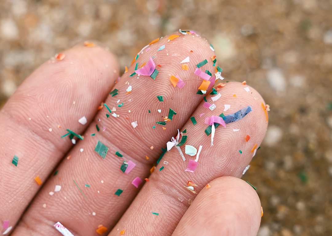 Close-up detail of microplastic particles on hand.