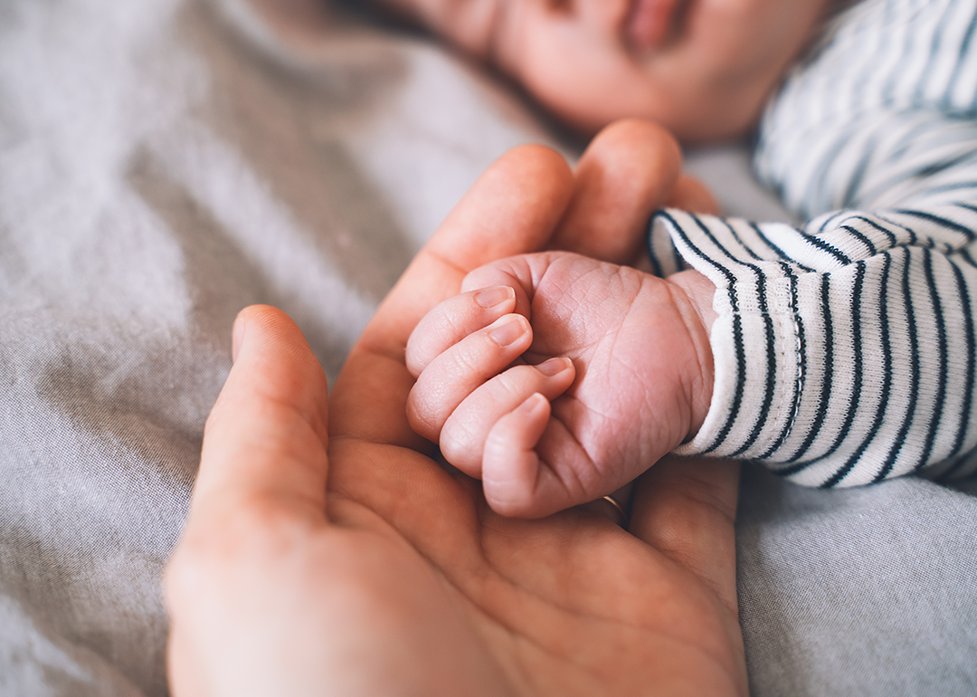 Baby's hand into parent hands. 