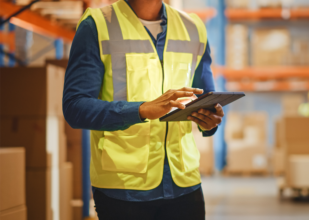 Worker in warehouse with tablet.