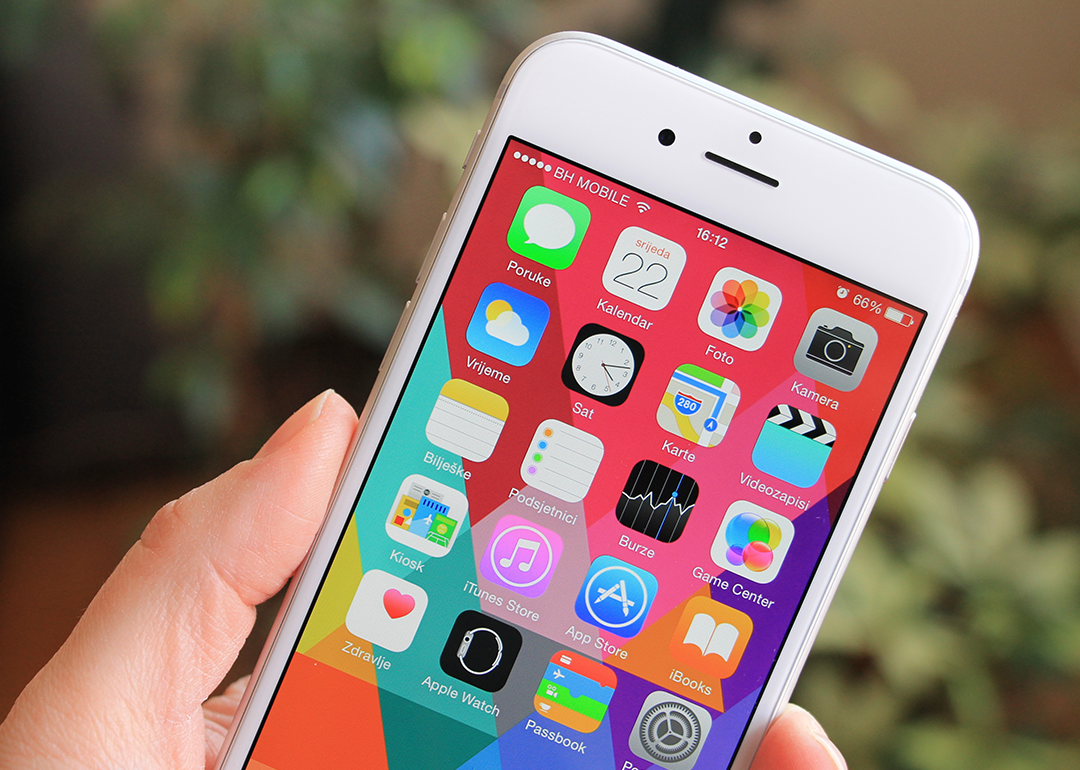 iPhone 6 with colorful screen in person’s hand.