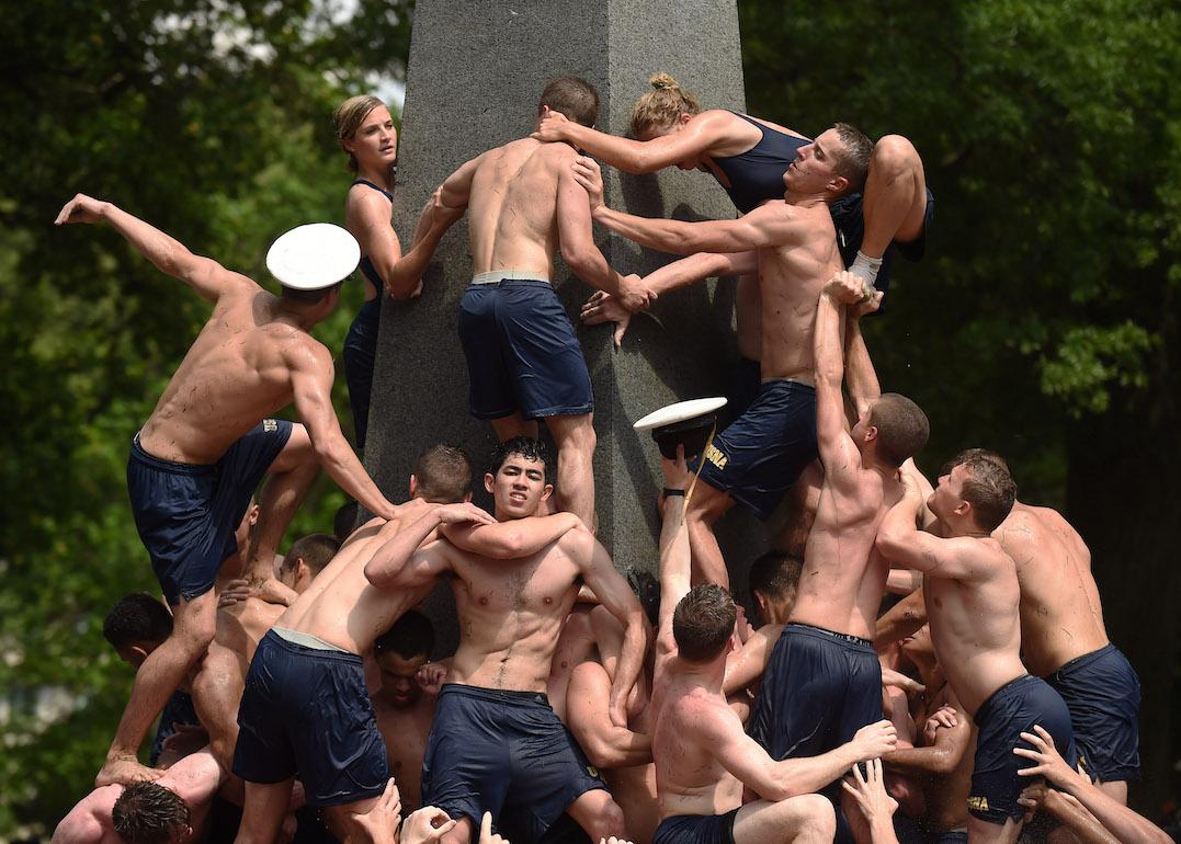 Plebes take part in the annual Herndon Monument Climb at the United States Naval Academy on Monday May 18, 2015 in Annapolis, MD