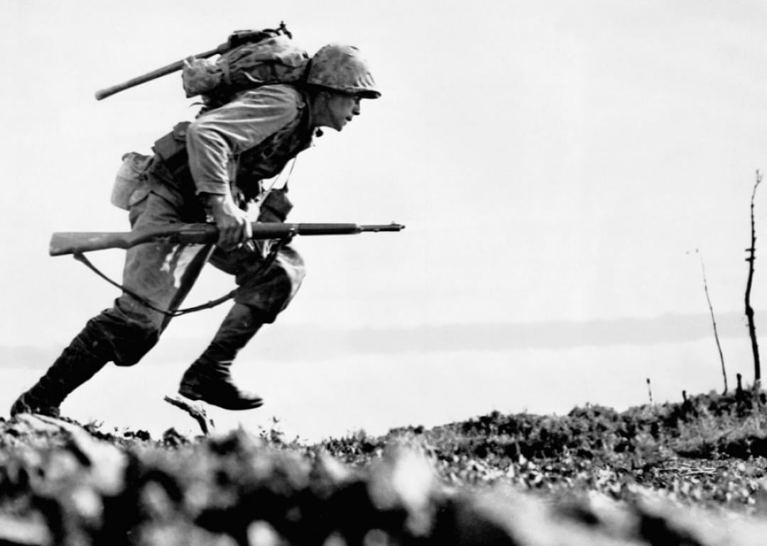 A U.S. Marine charges forward through Japanese machine gun fire on Okinawa