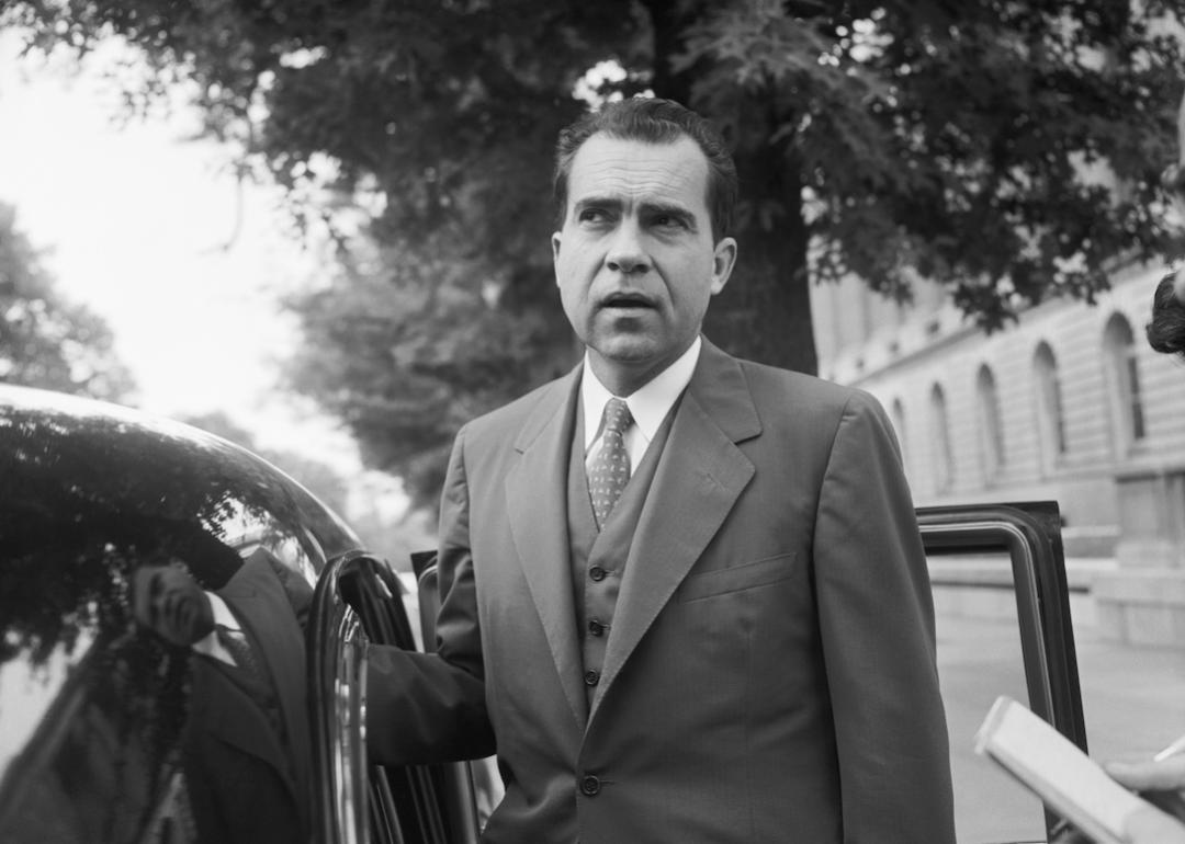 Richard Nixon speaks with members of the media before leaving his Capitol Hill office.