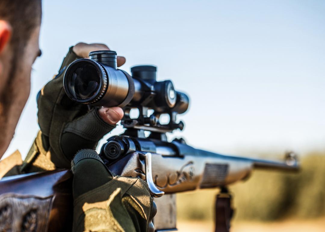 Closeup of hunter aiming rifle 