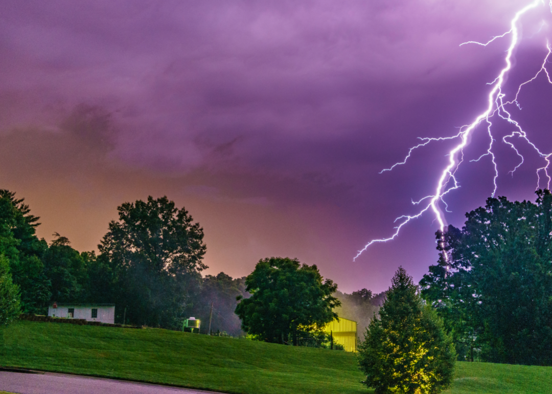 Lightning strikes in purple sky in green area of US