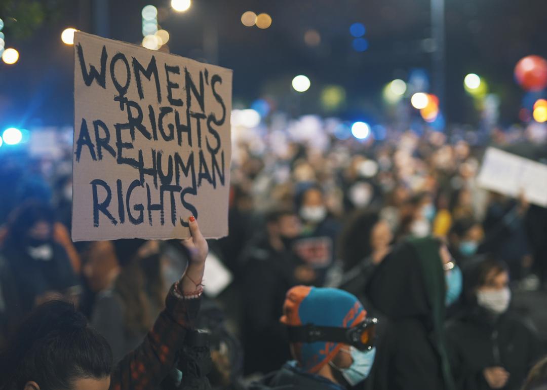Person holds up a sign that reads "Women's rights are human rights" at a protest