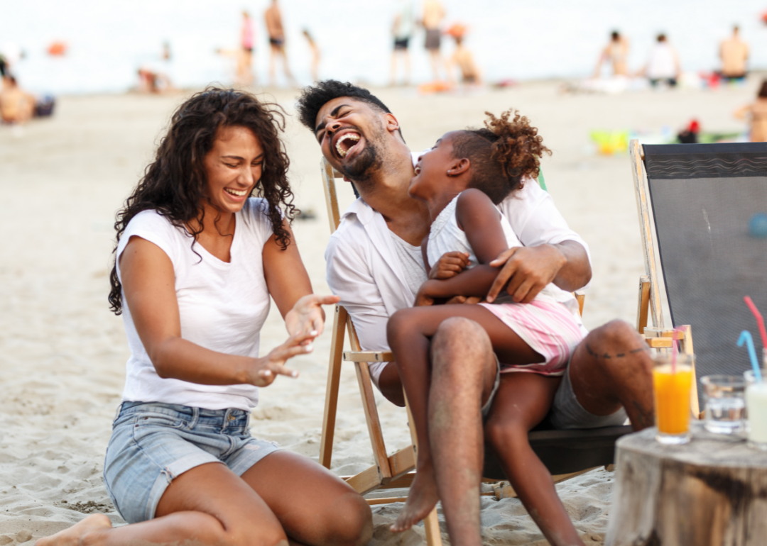 Family enjoys a laugh on the beach