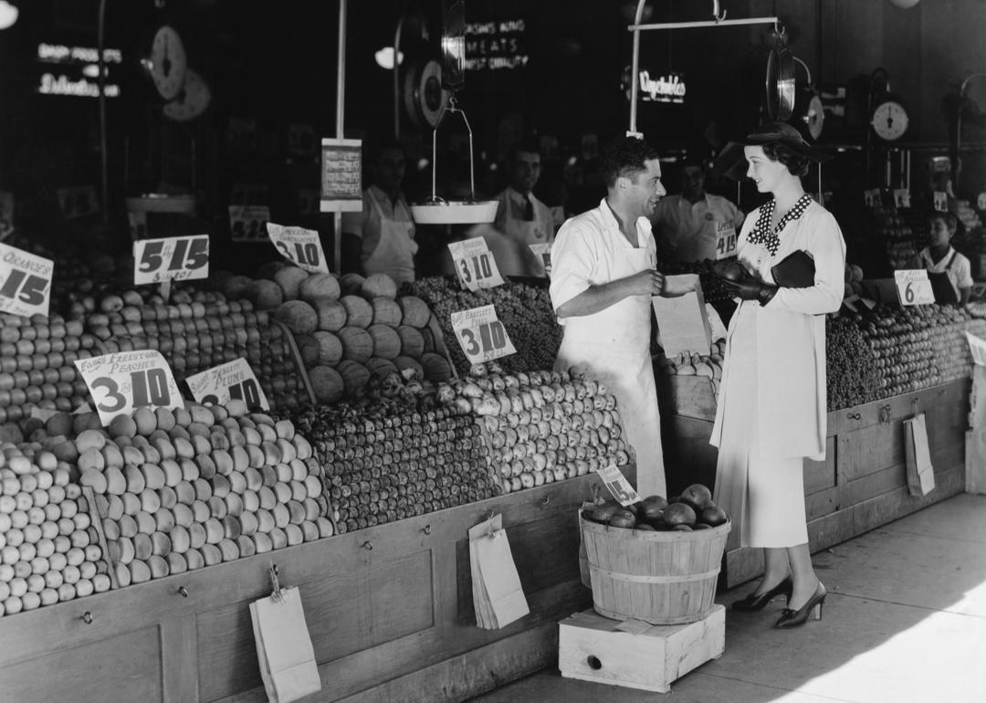 Vintage photo of woman and vendor at open air market