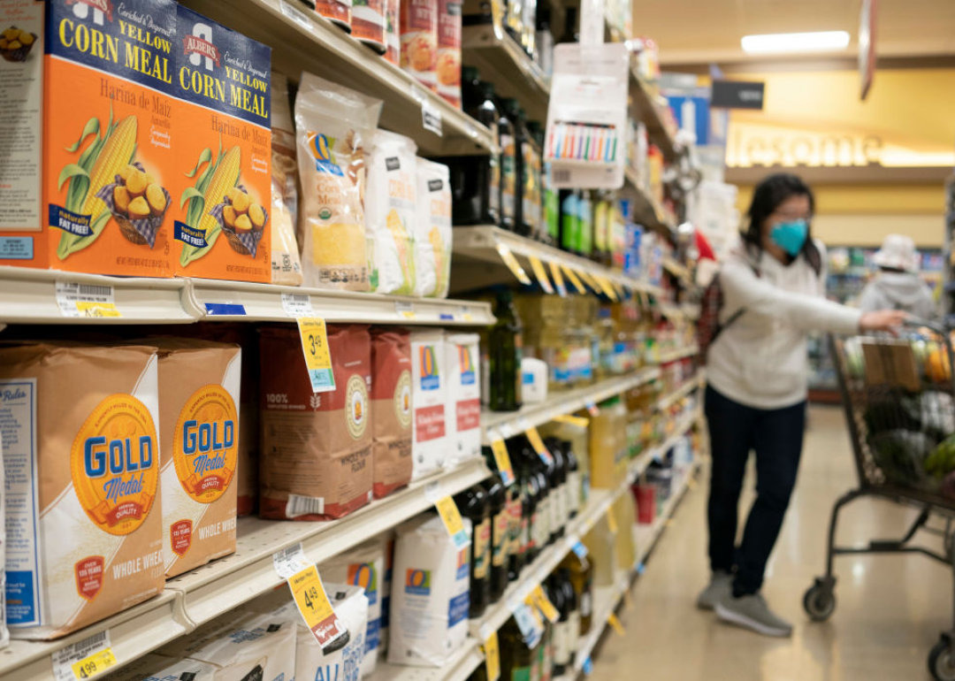 Woman in a grocery store shopping for flour in San Mateo, California