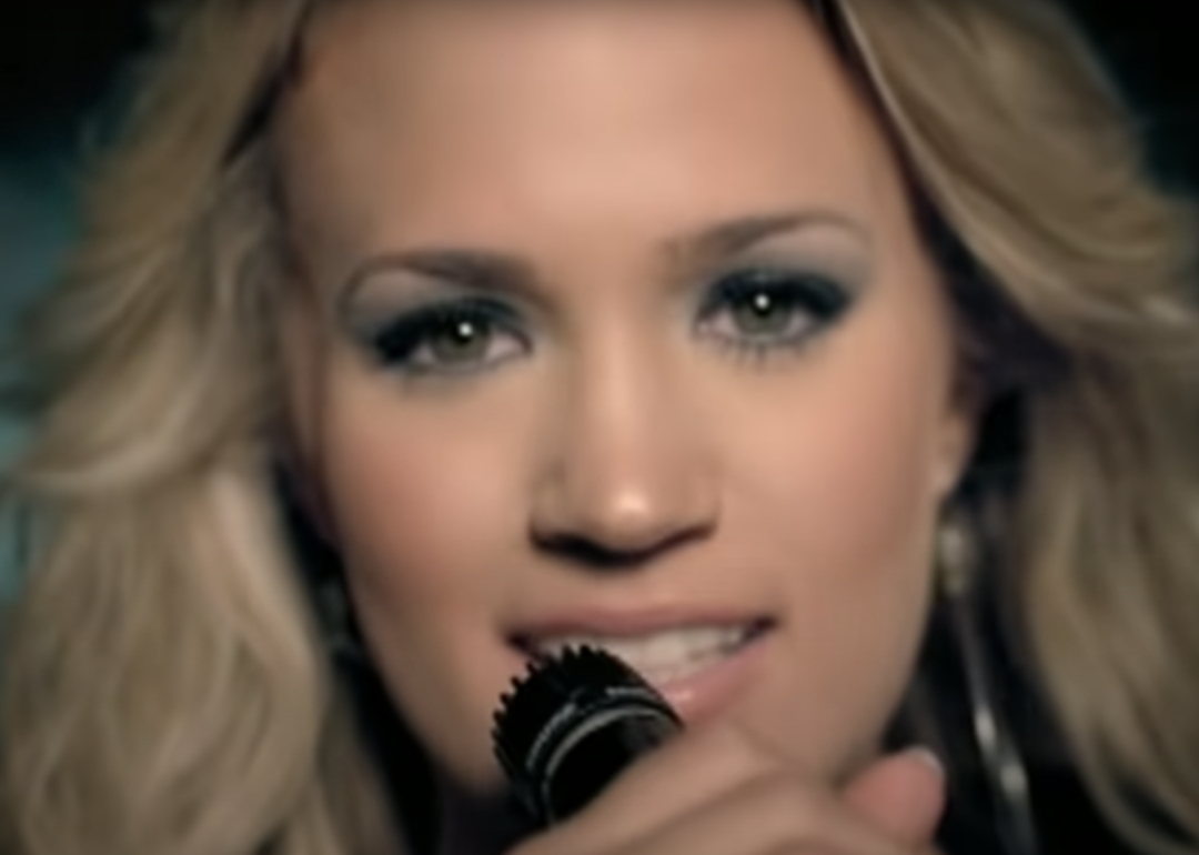 Carrie Underwood closeup holding microphone in "Before He Cheats" video