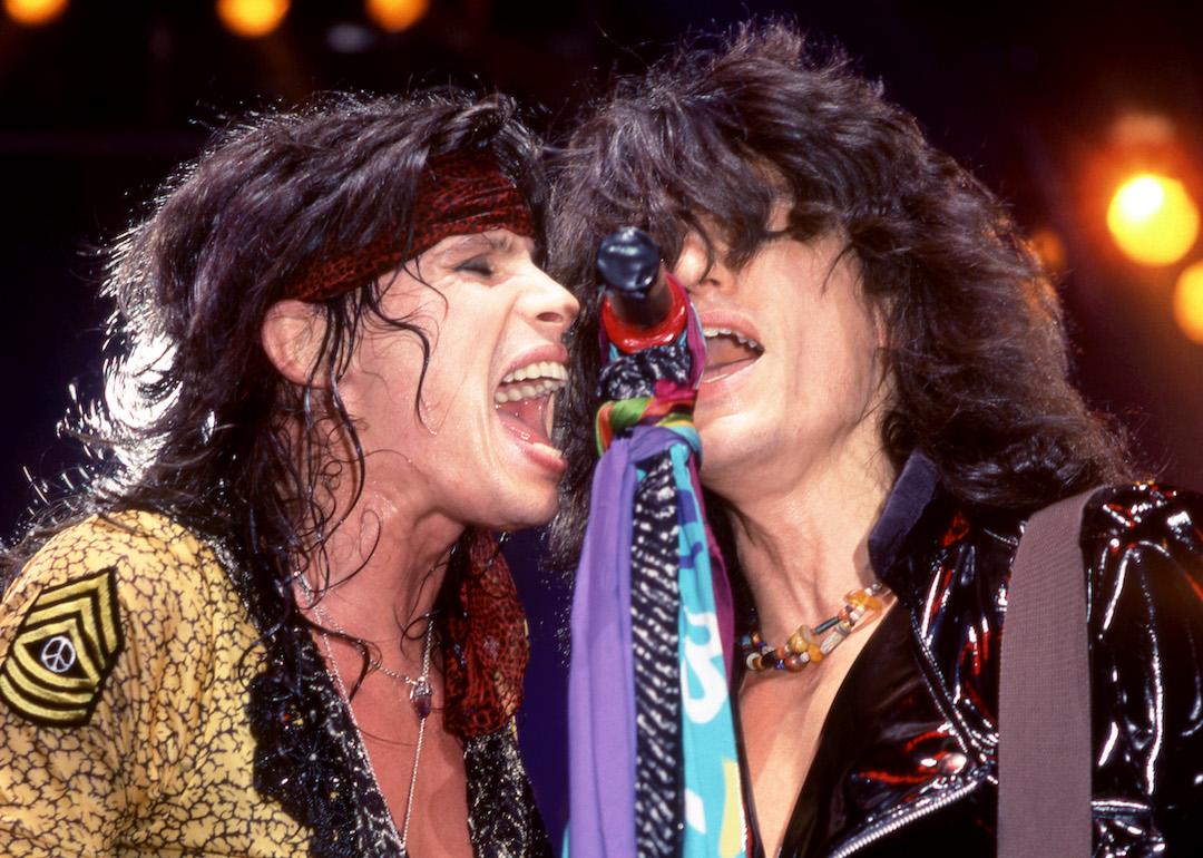 Lead singer Steven Tyler and lead guitarist Joe Perry of the American rock band Aerosmith sing on stage in 1987.