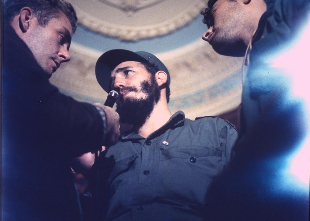Press interviewing victorious Fidel Castro en route to rebel victory celebration in Havana, Cuba, in 1959.