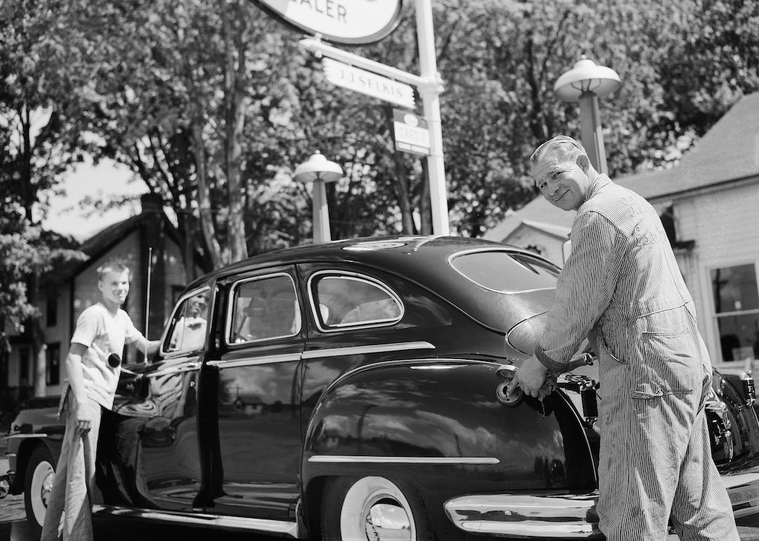 An attendant pumps gas into an automobile at an Esso filling station in Cape Vincent, NY in the 1940s..