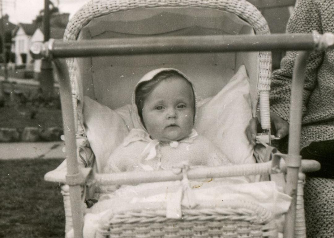 Vintage photo of baby girl in a stroller 