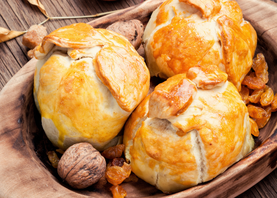 Apple dumplings on wooden surface