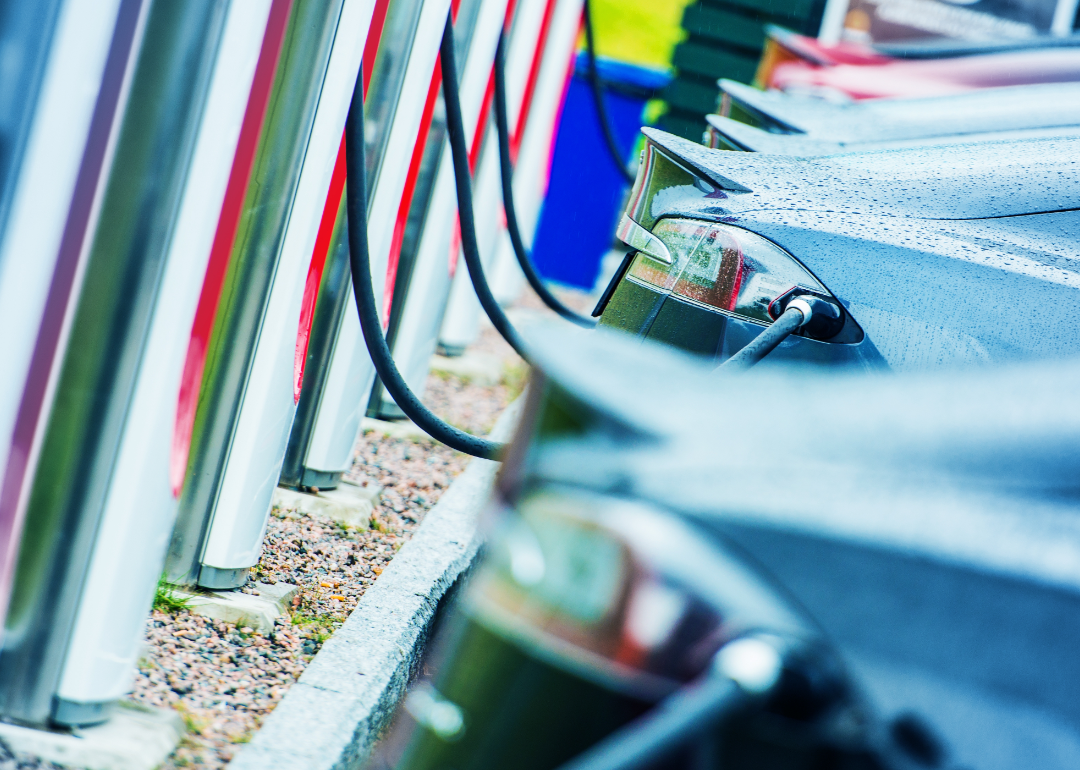 Multiple cars lined up at a charging station