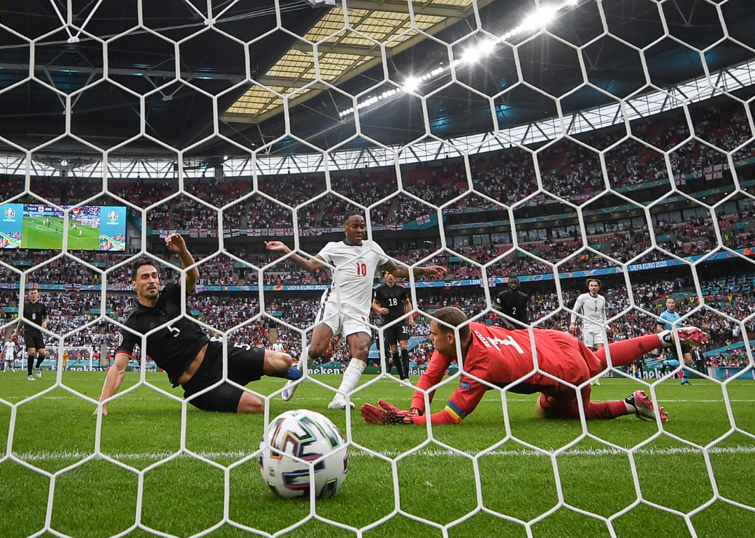 England's Raheem Sterling scoring a goal as seen through the goal net