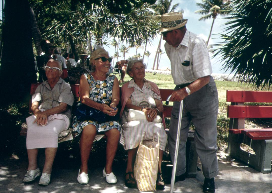 Retired friends sit on park benches in the South Beach area of Miami Beach in 1975