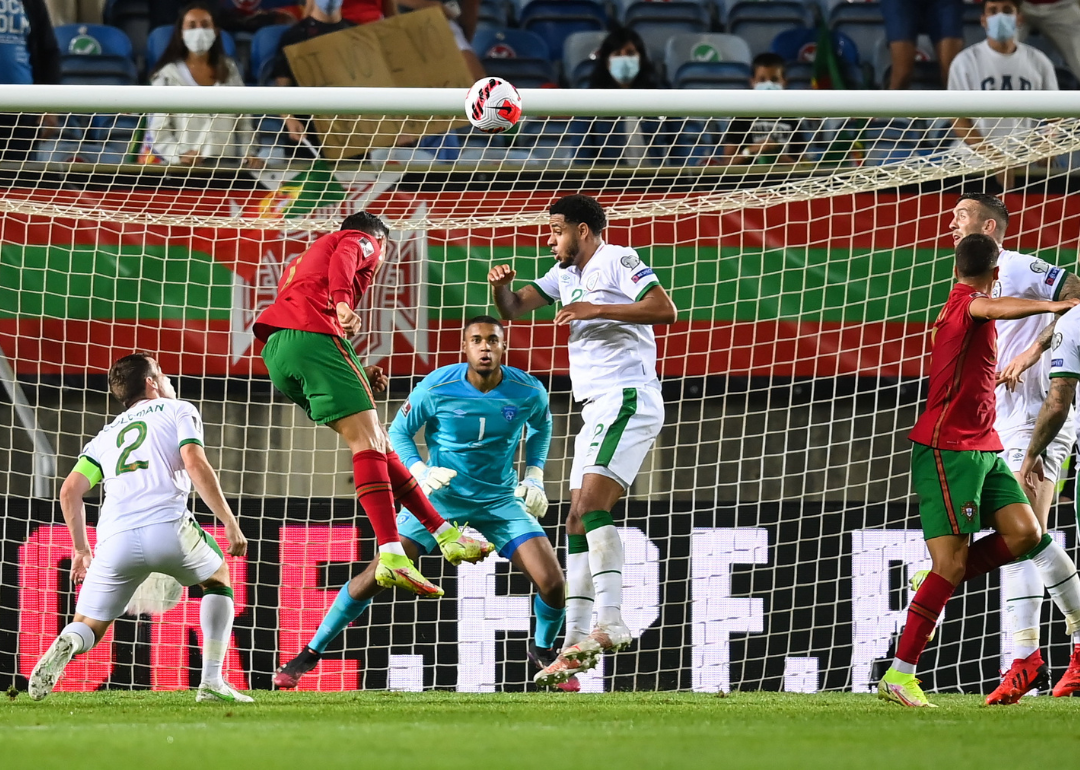 Cristiano Ronaldo of Portugal heads to score his side's second goal during the FIFA World Cup 2022 qualifying group