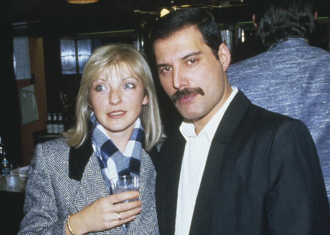 Singer Freddie Mercury of Queen attends Fashion Aid at the Royal Albert Hall in London, with Mary Austin, in 1985.