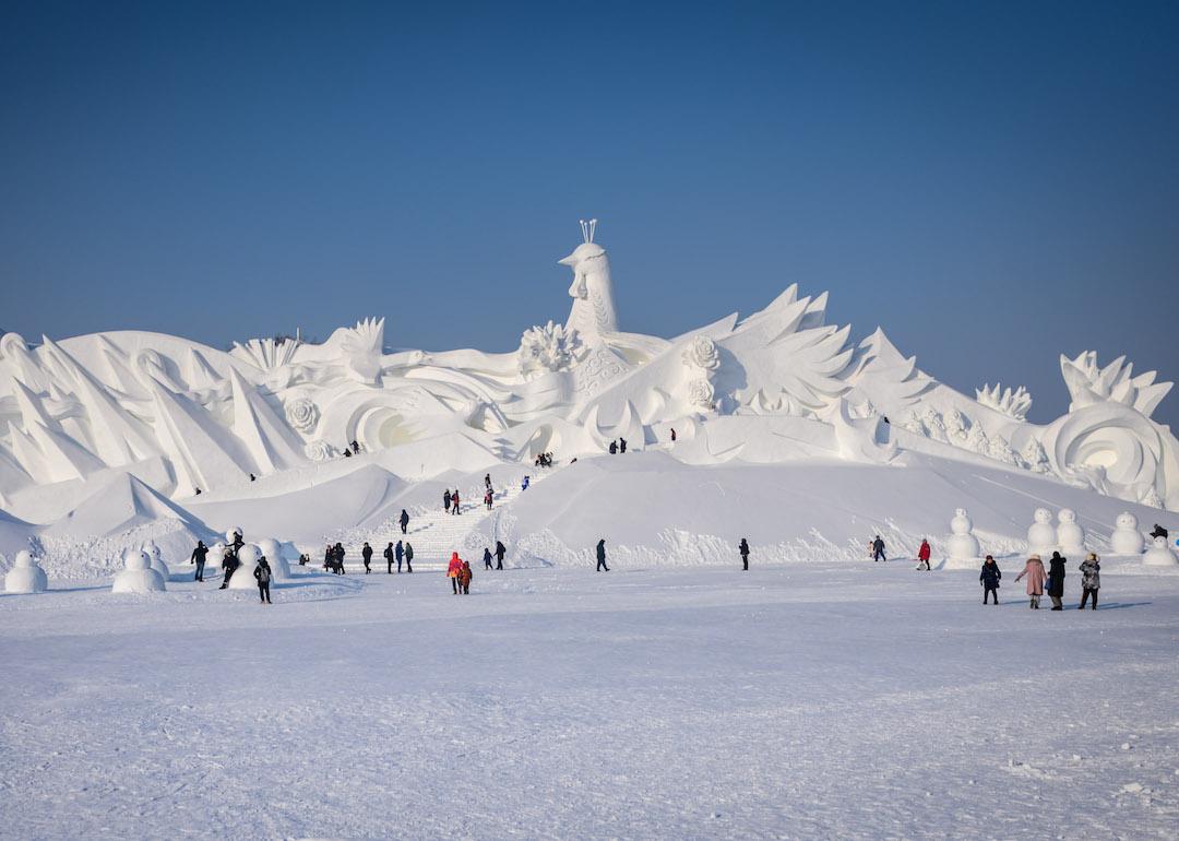 Tourists visit ice sculpture during the 36th Harbin Ice and Snow Festival in Harbin, Heilongjiang province. Harbin International Ice and Snow Sculpture Festival is one of the largest ice and snow festivals in the world and is a popular winter destination for both Chinese and foreign visitors.