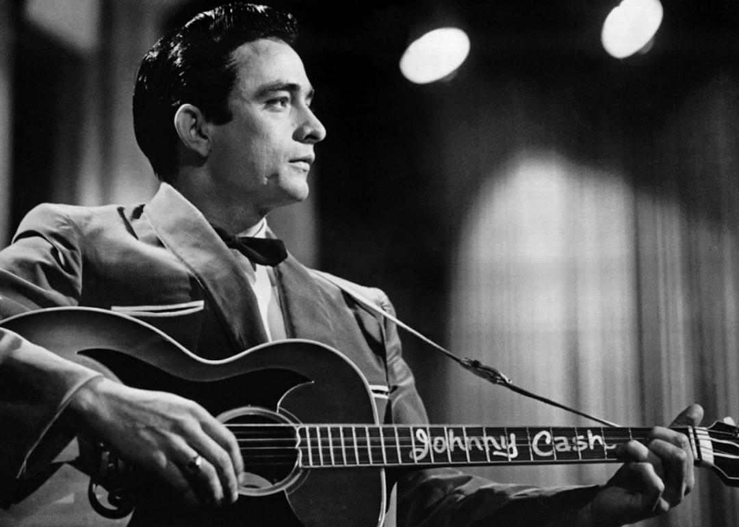 Johnny Cash holds his guitar on the 'Johnny Cash Show.'