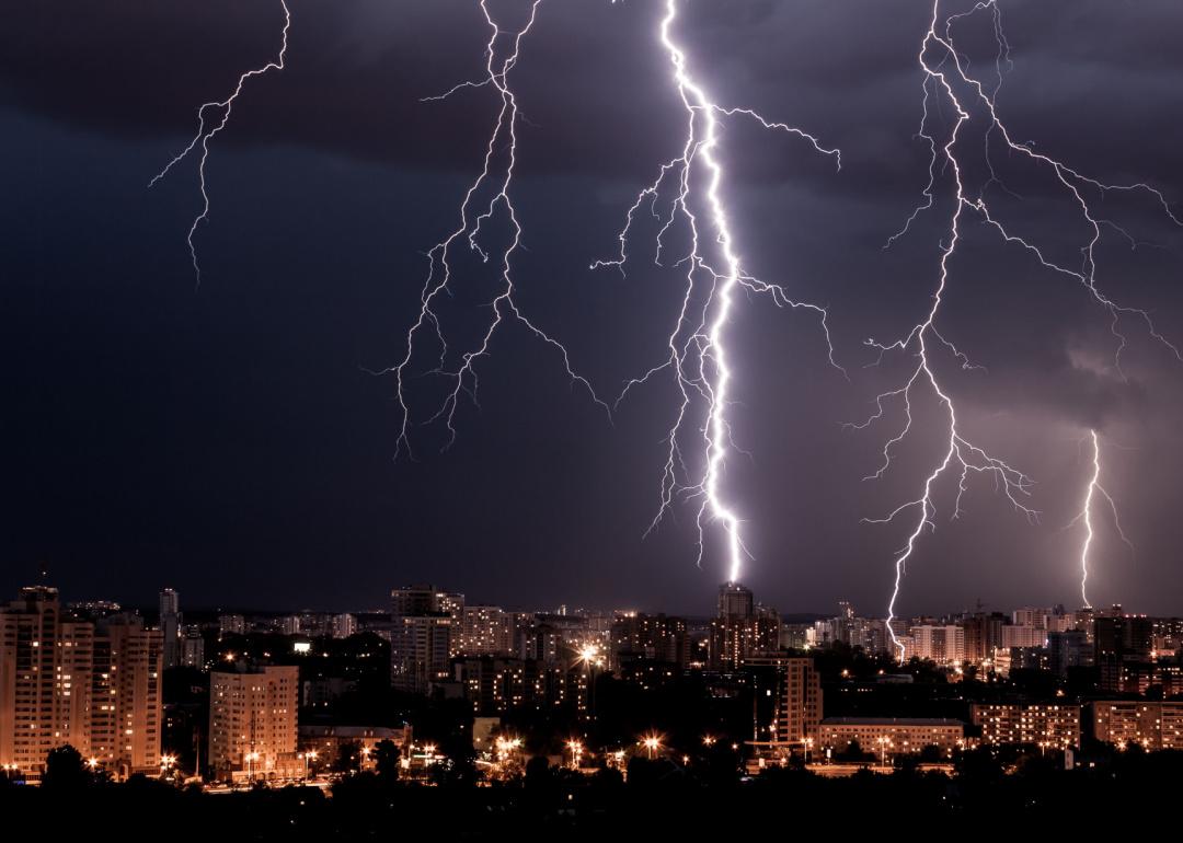 Lightning storm over city skyline at night