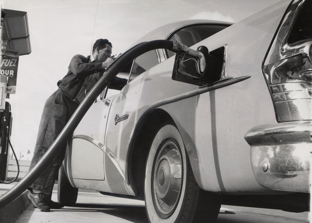 Driver filling up car with gas in Wendover, Utah, in 1950.
