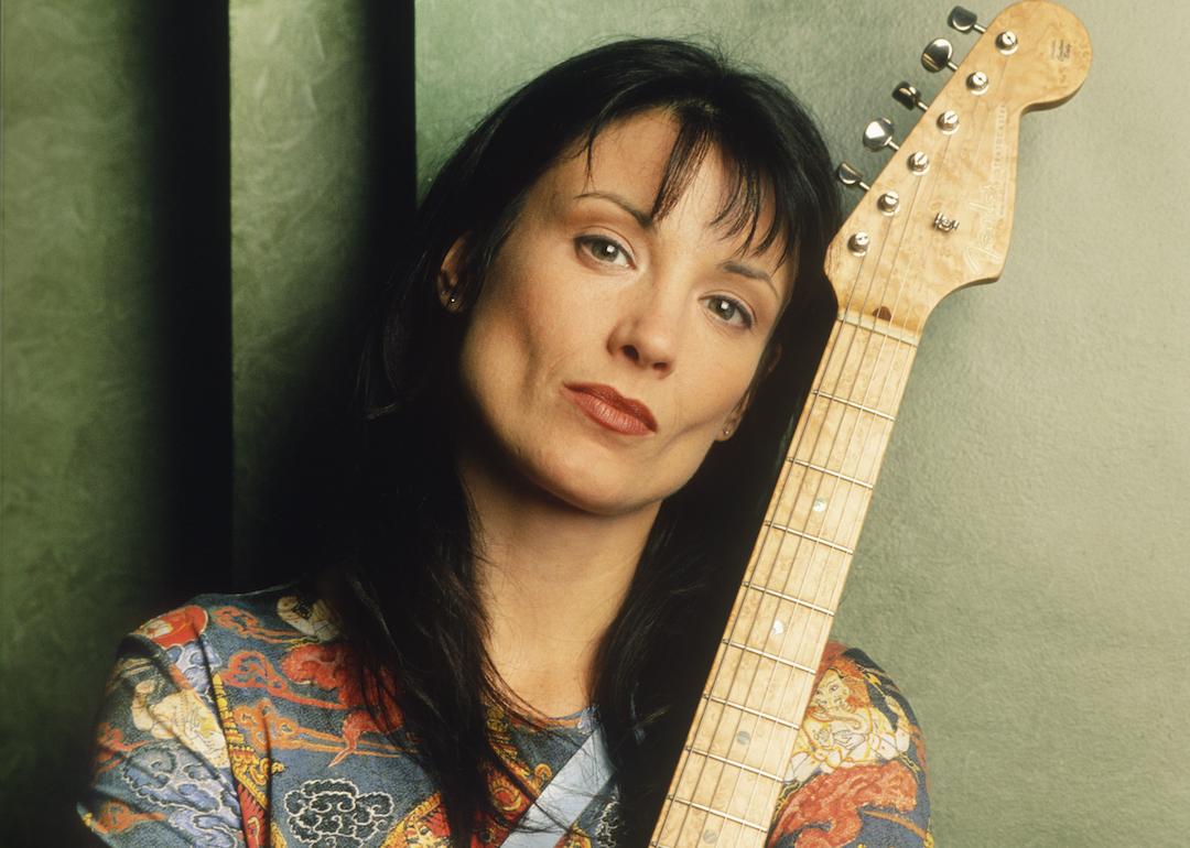 Meredith Brooks posing with Fender Stratocaster guitar in 1997.