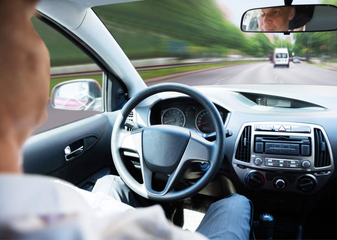 View of steering wheel that the driver is not holding because they're in a self-driving car.