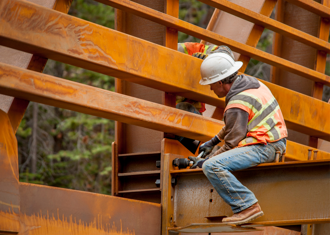 Steel workers constructing a bridge.