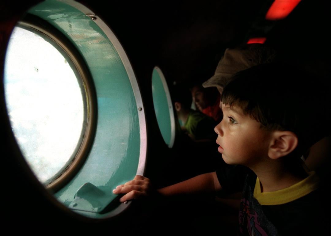 A young child looks out of the submarine in Disneyland's former ride Submarine Voyage.