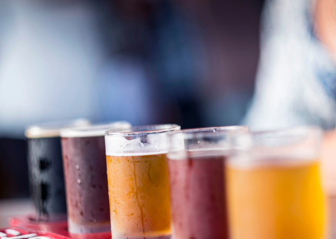 Selection of craft beers of different shades in a flight.