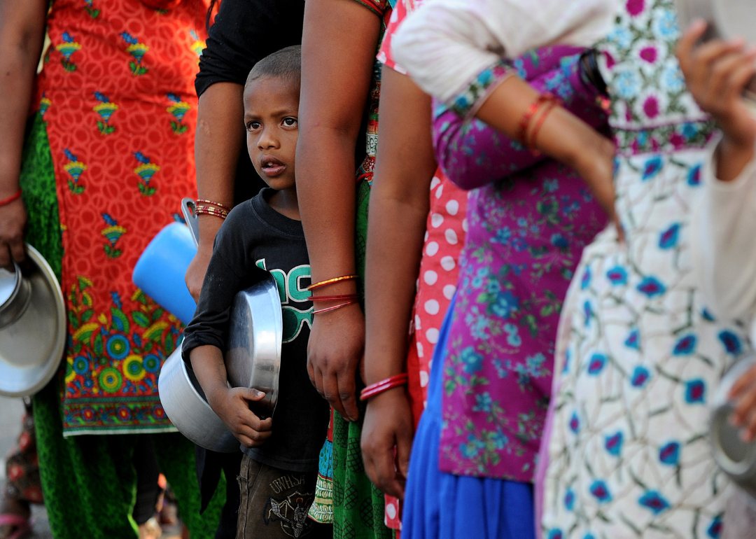 Nepalese people queue to receive food and goods at a relief camp for survivors of the Nepal earthquake