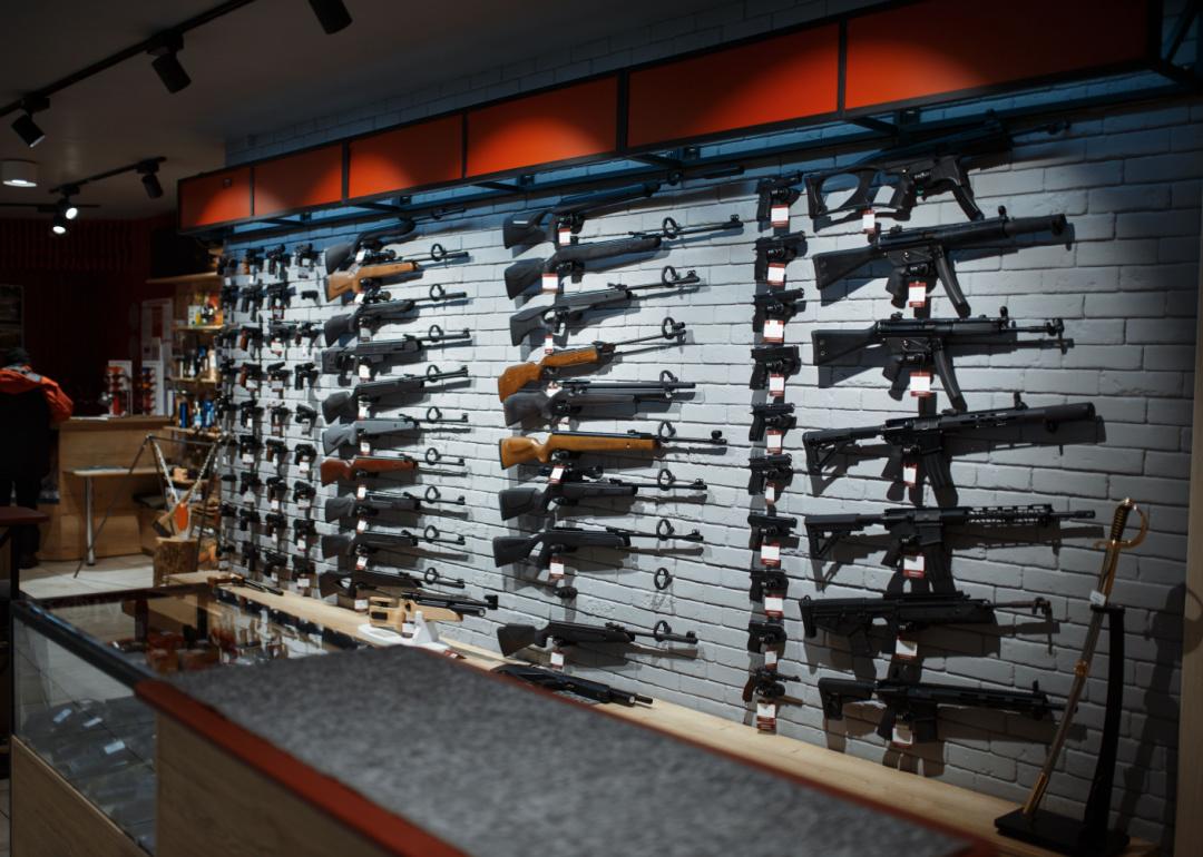 Guns on a display wall in a gun store.