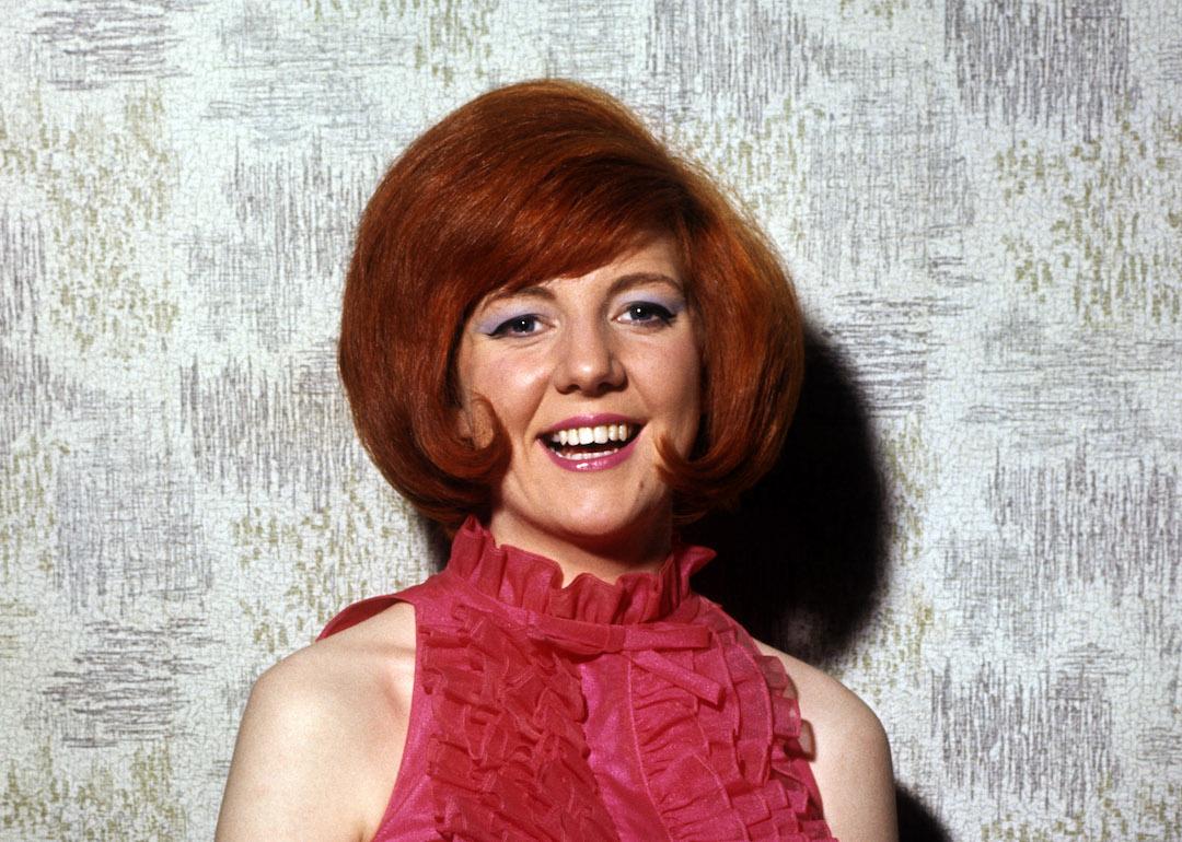 British pop singer and 1960s one-hit wonder Cilla Black wearing a pink halter dress.