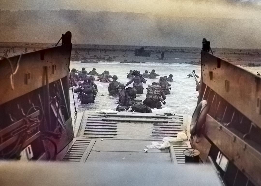 Digitally colorized image of "Into the Jaws of Death," a photograph by Robert F Sargent of the United States Army First Infantry Division disembarking from an LCVP (landing craft) onto Omaha Beach during the Normandy Landings on D Day during World War 2, June 6, 1944.
