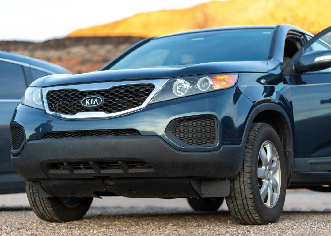 A close-up shot of a black 2019 KIA outdoors.