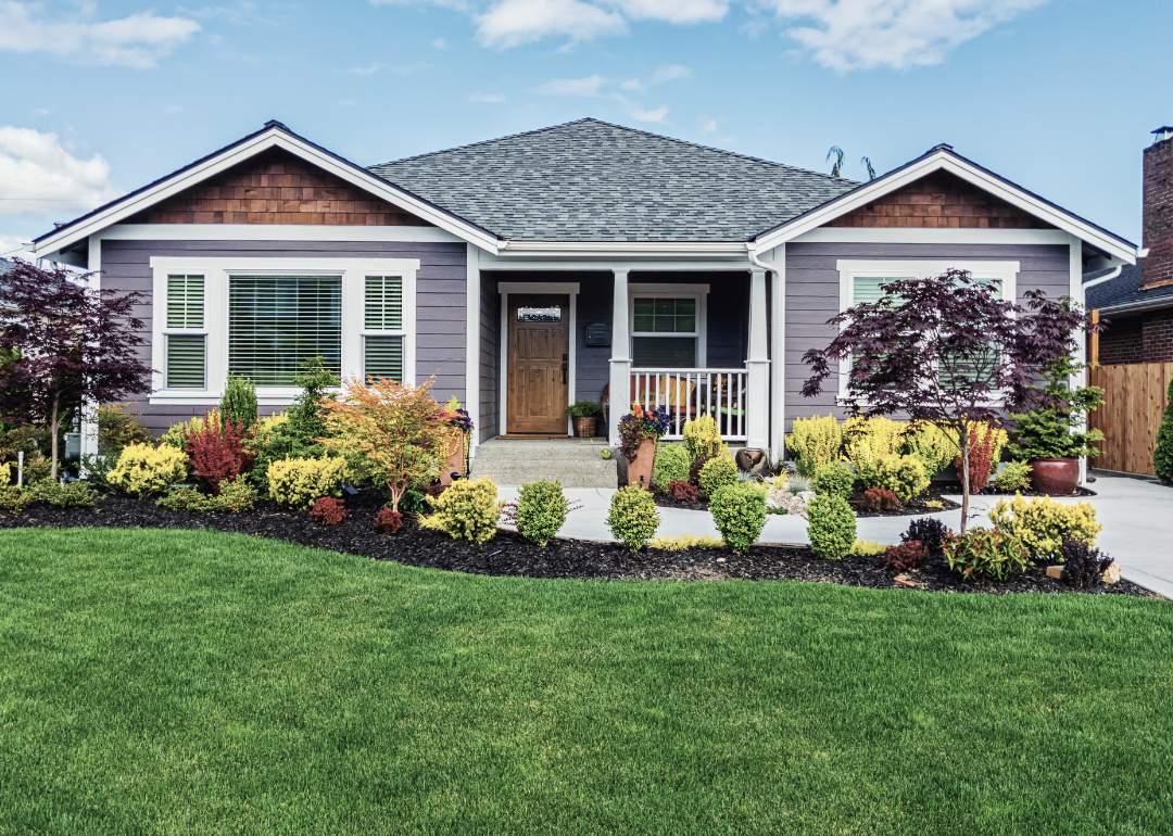 Exterior of a small home with detailed landscaping.