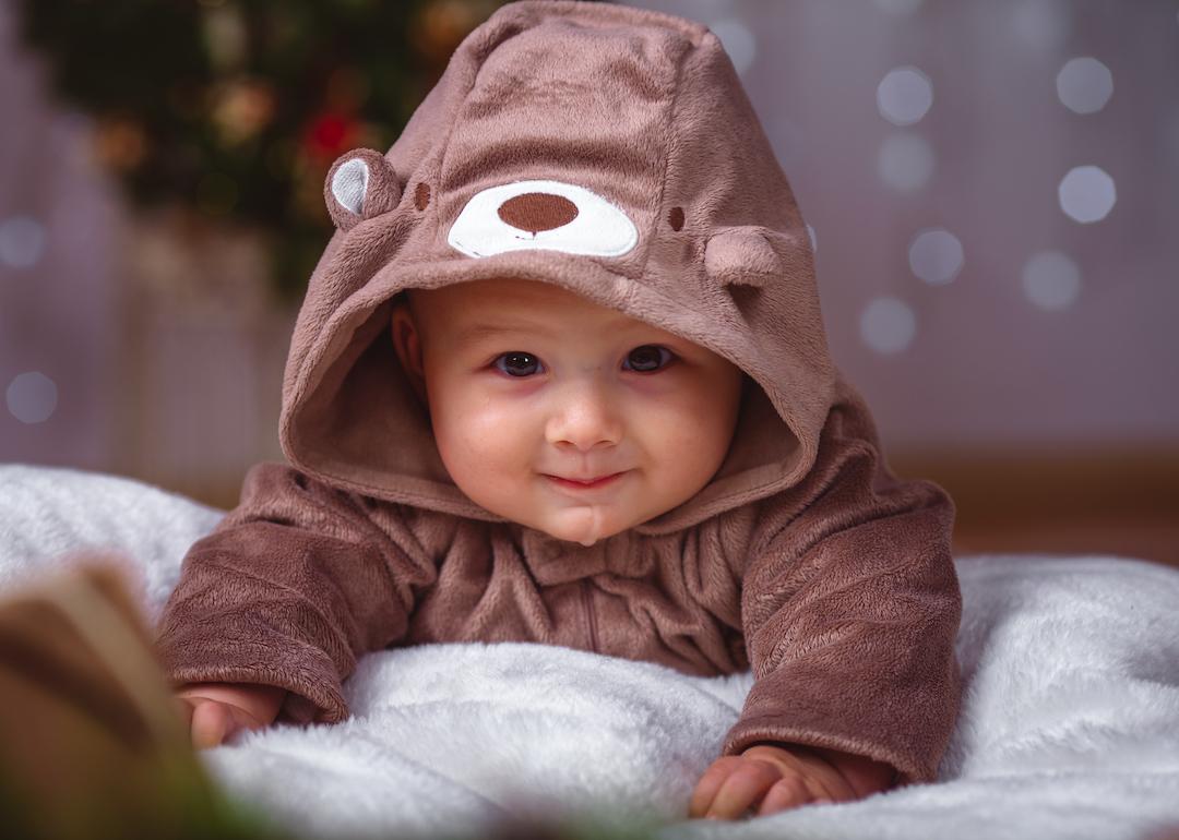Infant baby in bear outfit.