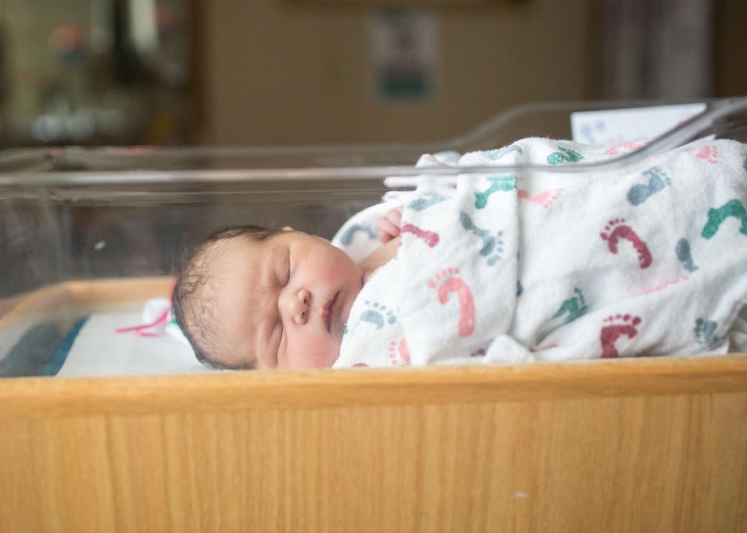 Sleeping newborn baby in a hospital blanket.