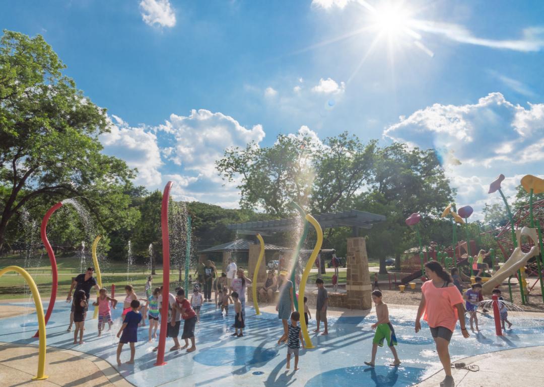 Kids enjoy water splash pad at Parr Park in Grapevine, Texas.