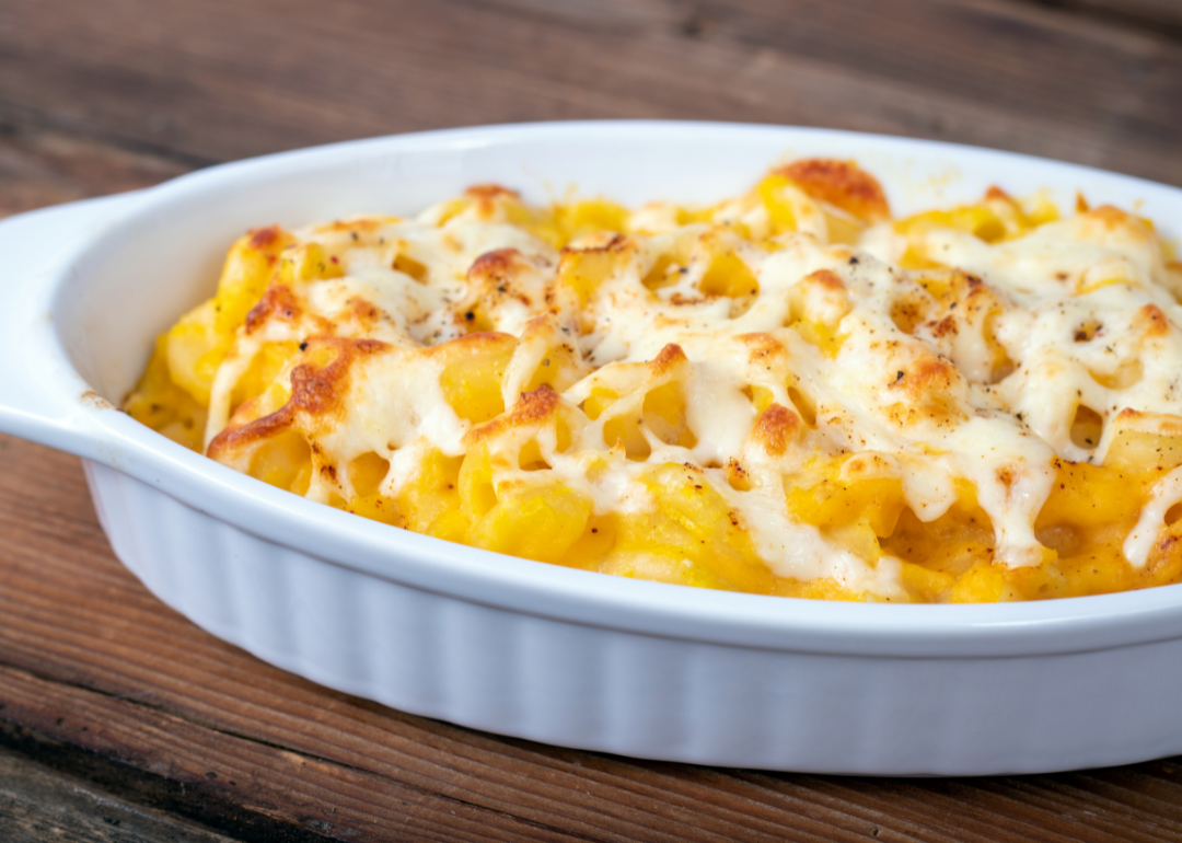 Butternut squash mac and cheese in a white dish.