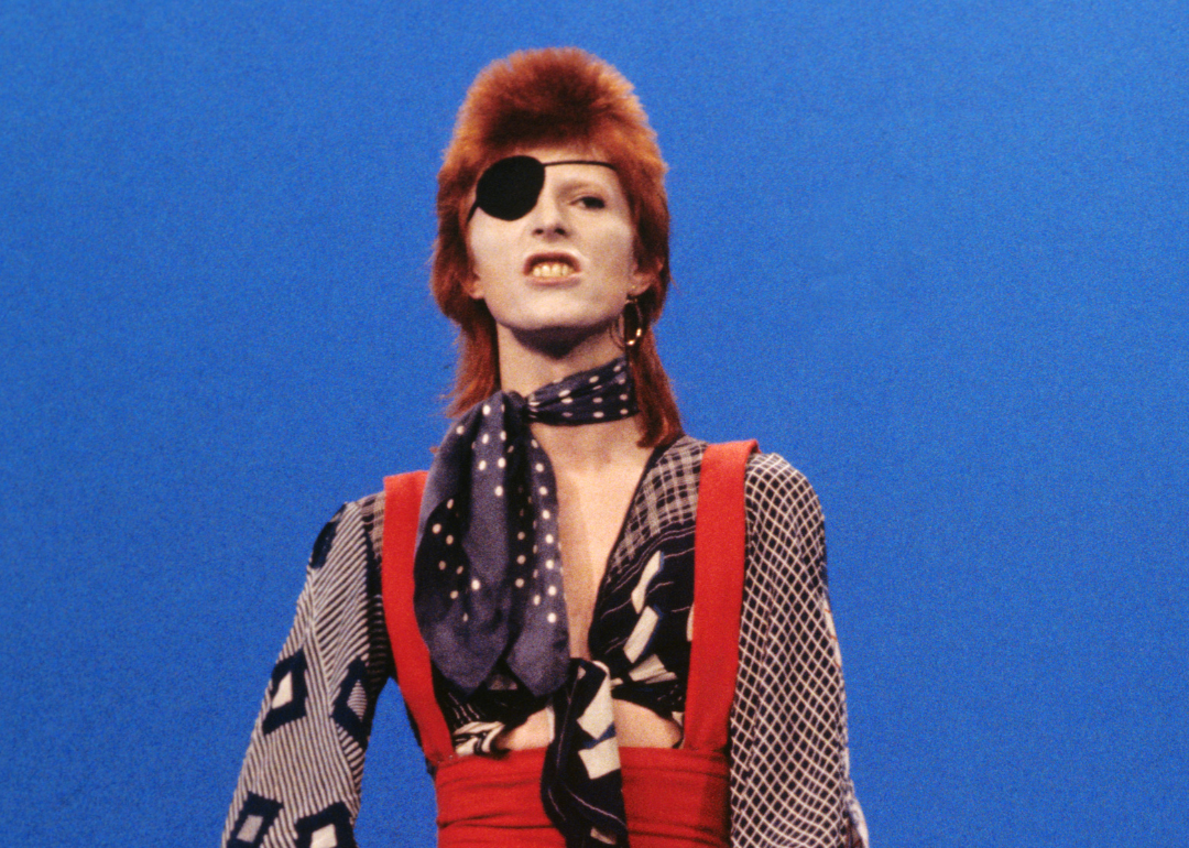 Musician David Bowie poses for a portrait wearing and eye patch and colorful printed clothes before performing on the TV show TopPop in Hilversum, Netherlands, 1974.